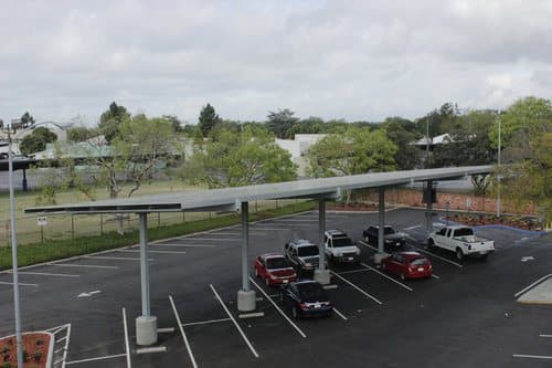 Aerial view of solar canopy rows with cars parked beneath