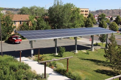 Solar canopy beside a landscaped multifamily courtyard