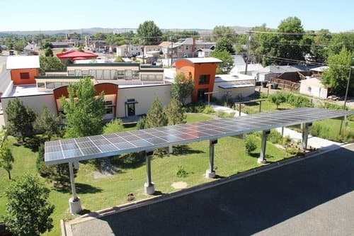 Solar canopy over parking next to a residential garden