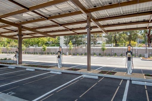 Solar carport with electric vehicle chargers mounted at the column line