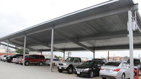 Row of T-cantilever solar carports over a commercial lot