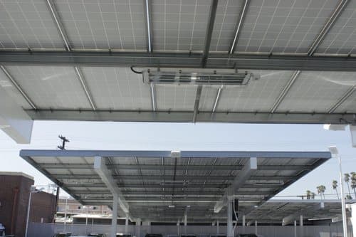 Underside of a solar canopy showing slide-in purlins and modules